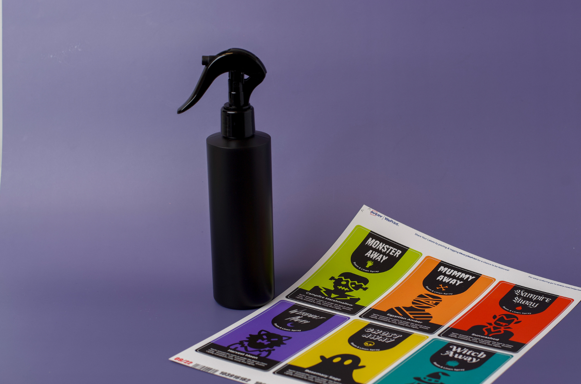 A spray bottle with a sheet of various monster away labels.